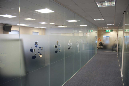 A glass partition with corporate logo incorporated into the glass panel
